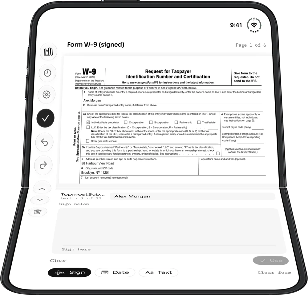 A W-9 form signed on a half-open iPhone Duo, the signature pad on the flat half